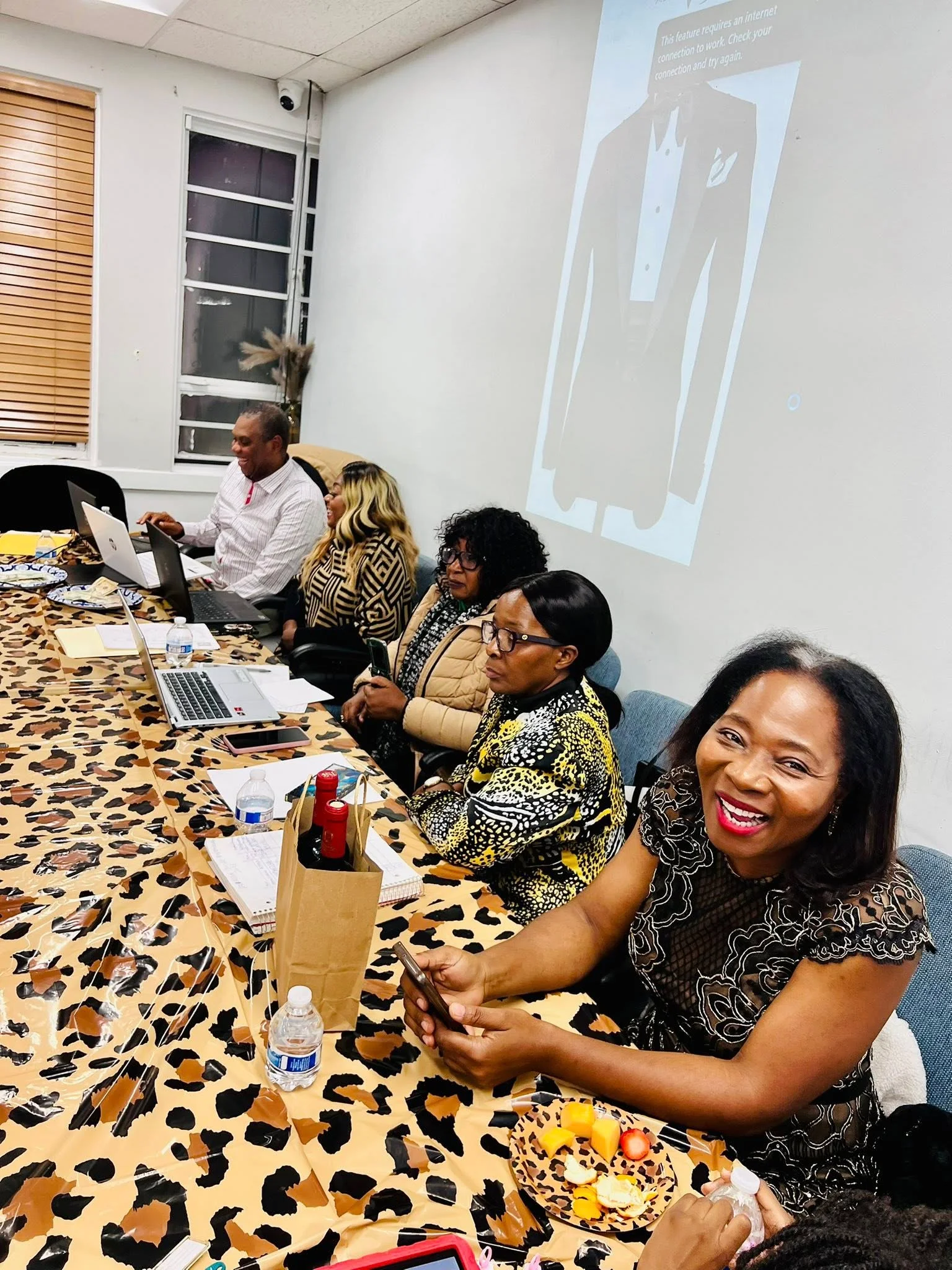 OYILI BETI USA members gathered around the table at the April 2026 monthly meeting